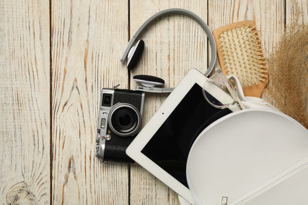 Stylish urban backpack with different items on white wooden background, flat layの写真素材