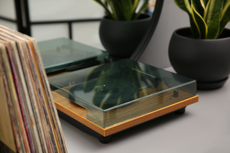 Stylish turntable and vinyl records on table indoorsの写真素材