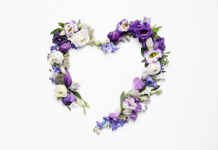 Beautiful heart made of different flowers on white background, top viewの写真素材