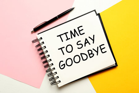 Notebook with text Time to say goodbye on color background, flat layの写真素材