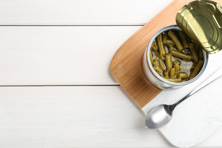 Canned green beans on white wooden table, top view. Space for textの写真素材