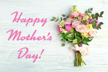 Happy Mother's Day. Bouquet of beautiful flowers on white wooden background, top viewの写真素材