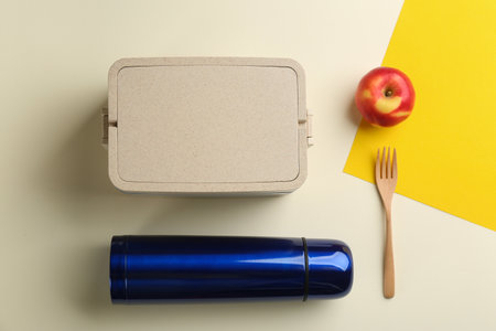 Thermo, lunch box and apple on color background, flat layの写真素材