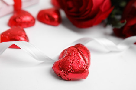 Tasty heart shaped chocolate candies on white background, closeup. Valentine's day celebrationの写真素材