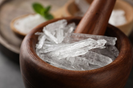 Menthol crystals in wooden mortar, closeup viewの写真素材