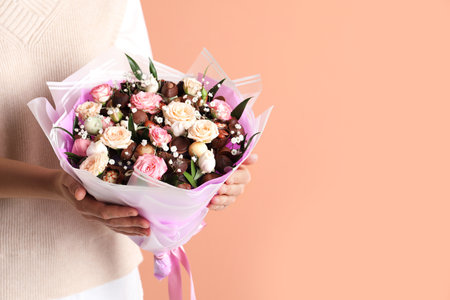 Woman with beautiful food bouquet on brown background, closeup. Space for textの写真素材