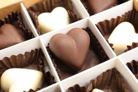 Tasty heart shaped chocolate candies in box, closeup. Valentine's day celebrationの写真素材