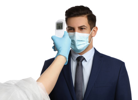 Doctor measuring man's temperature on white background, closeup.の写真素材