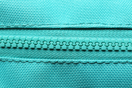Turquoise fabric with zipper as background, closeup viewの写真素材