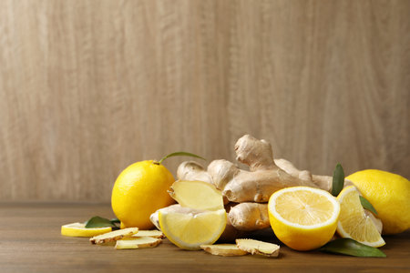 Fresh lemons and ginger on wooden table. Space for textの写真素材