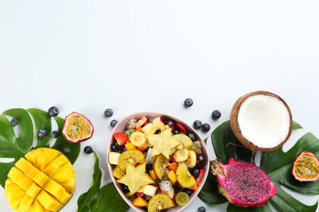 Composition with delicious exotic fruit salad on white background, top viewの写真素材