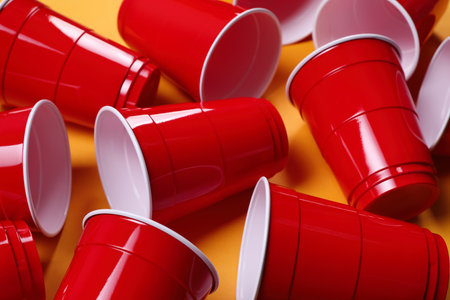 Red plastic cups for beer pong game on orange background, closeupの写真素材