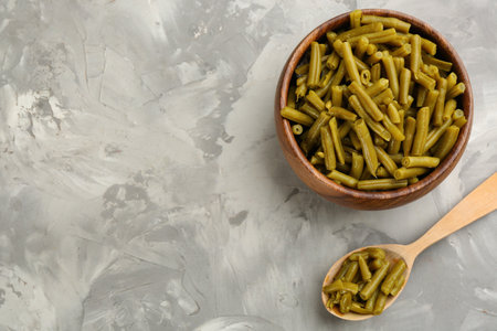 Canned green beans on gray table, flat lay. Space for textの写真素材