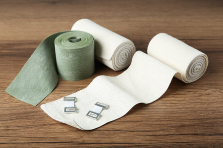 Different medical bandage rolls on wooden backgroundの写真素材