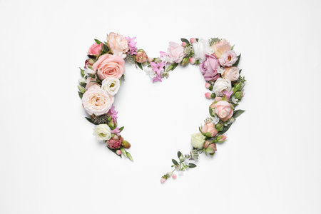 Beautiful heart made of different flowers on white background, top viewの写真素材