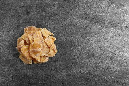 Delicious dried jackfruit slices on dark gray table, top view. Space for textの写真素材