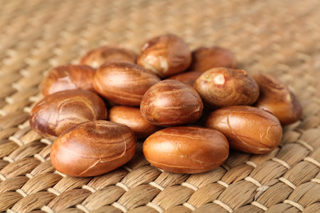 Many raw jackfruit seeds on wicker mat, closeupの写真素材