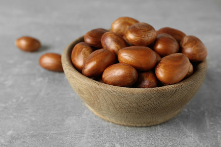 Wooden bowl with jackfruit seeds on light gray table, closeupの写真素材