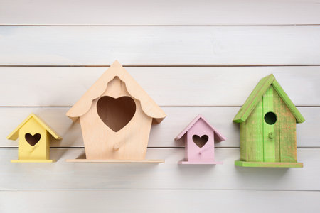 Collection of handmade bird houses on white wooden background, flat layの写真素材