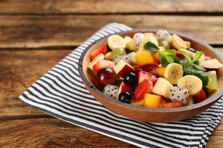 Delicious exotic fruit salad on wooden tableの写真素材