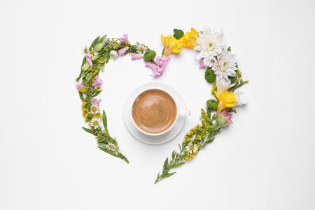 Beautiful heart made of different flowers and coffee on white background, top viewの写真素材
