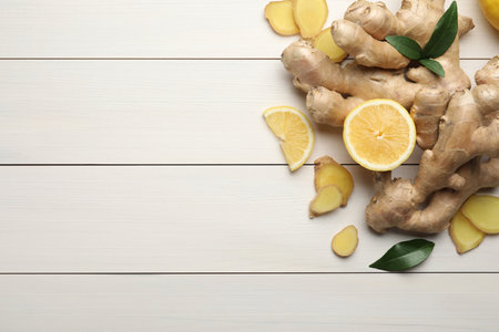 Fresh lemon and ginger on white wooden table, flat lay. Space for textの写真素材
