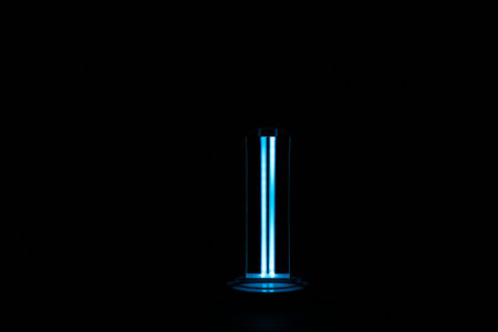 Modern ultraviolet lamp glowing on black backgroundの写真素材