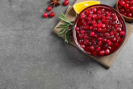 Flat lay composition with cranberry sauce on gray table, space for textの写真素材