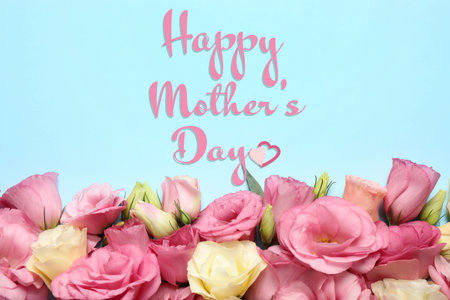 Happy Mother's Day. Beautiful eustoma flowers on light blue background, flat lay.の写真素材