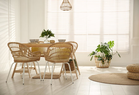 Stylish wooden dining table and chairs in the room. interior designの写真素材