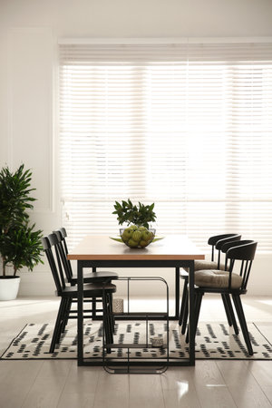 Stylish wooden dining table and chairs in the room. interior designの写真素材