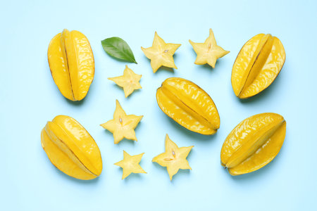Delicious carambola fruits on light blue background, flat layの写真素材