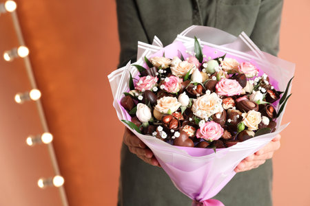 Woman with beautiful food bouquet on brown background, closeupの写真素材