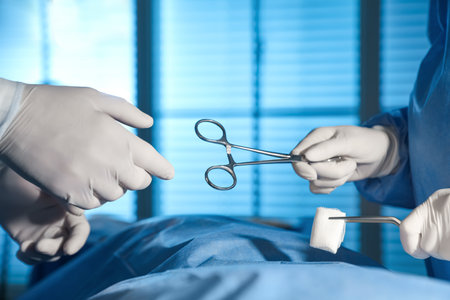 Professional surgeons with instruments performing operation in clinic, closeupの写真素材