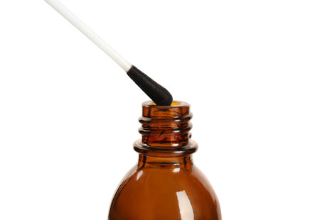 Bottle of medical iodine and cotton bud on white background, closeupの写真素材