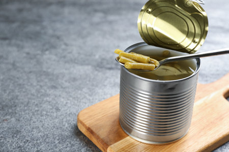 Canned green beans on gray table, closeup. Space for textの写真素材