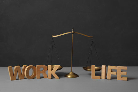 Words Life and Work made of wooden letters near scales on gray table. balance conceptの写真素材