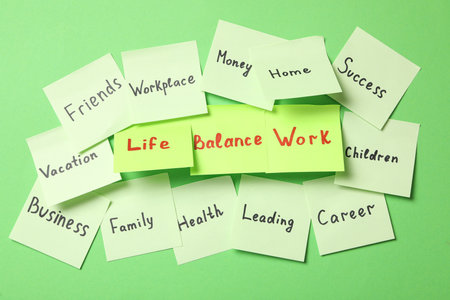 Sticky notes with words on green background. Life and work balance conceptの写真素材