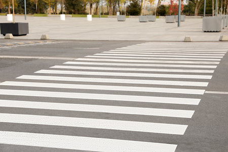 White pedestrian crossing on empty city streetの写真素材