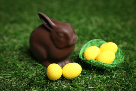 Chocolate bunny and eggs on green grass. easter celebrationの写真素材