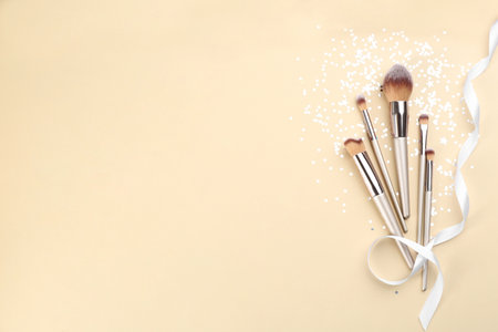 Flat lay composition with makeup brushes on gray background, space for textの写真素材