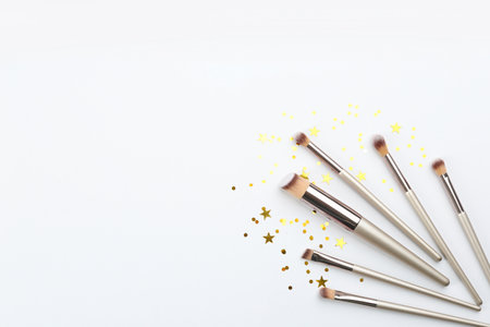 Flat lay composition with makeup brushes on white background, space for textの写真素材