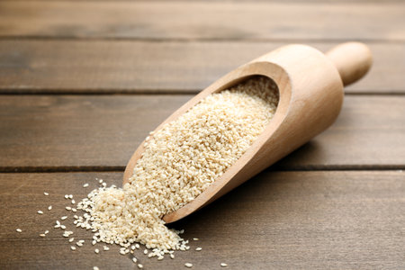 Sesame seeds in scoop on wooden tableの写真素材
