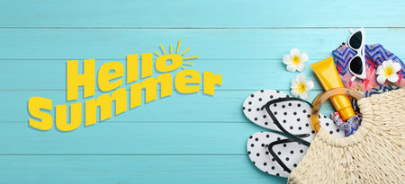 hello summer. Flat lay composition with beach accessories on light blue wooden background, banner designの写真素材