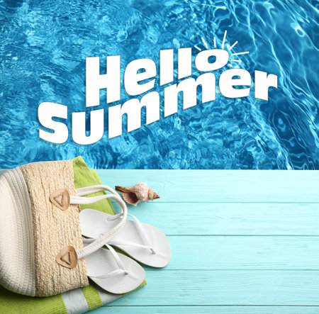 hello summer. Beach accessories on light blue wooden deck near swimming pool, flat layの写真素材