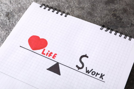 Drawing with words Life and Work in open notebook on gray table, above view. balance conceptの写真素材