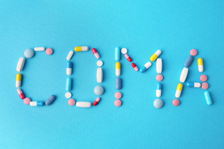 Word Coma made of pills on light blue background, flat layの写真素材