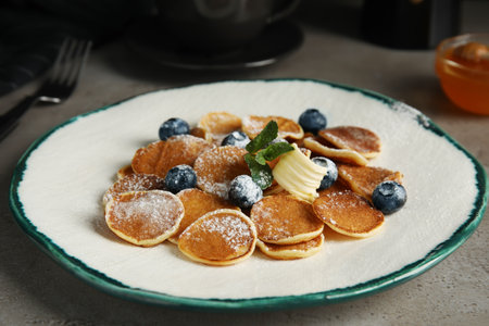 Cereal pancakes with blueberries and butter on gray tableの写真素材