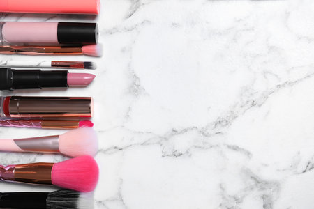 Different luxury makeup products on white marble table, flat lay. Space for textの写真素材