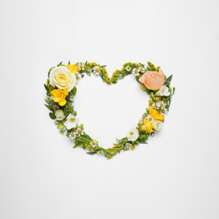 Beautiful heart made of different flowers on white background, top viewの写真素材